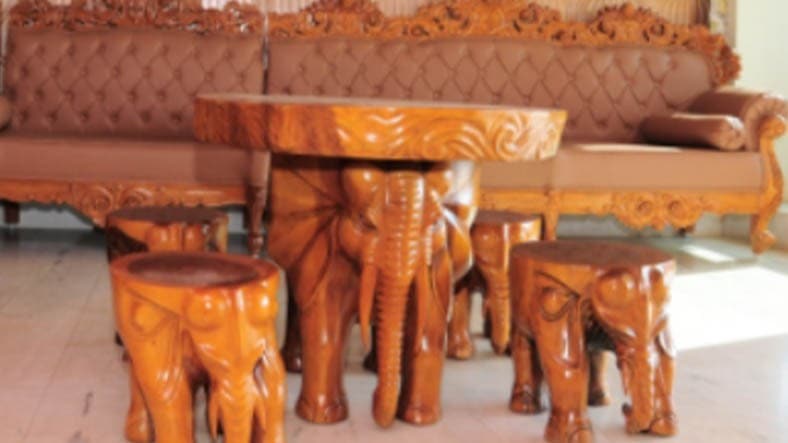 Hand-carved wooden elephant stools and table in the hotel lounge