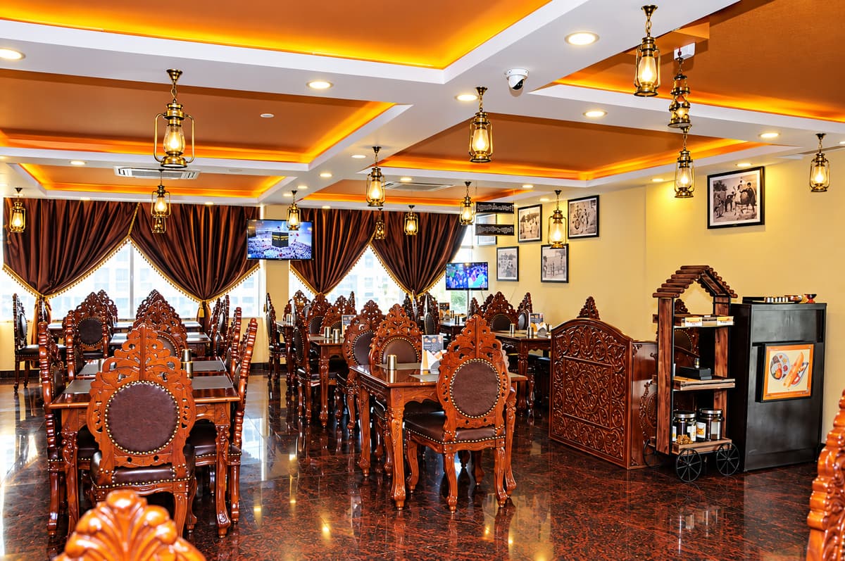 The restaurant with hand-carved wooden chairs and brass lantern lights
