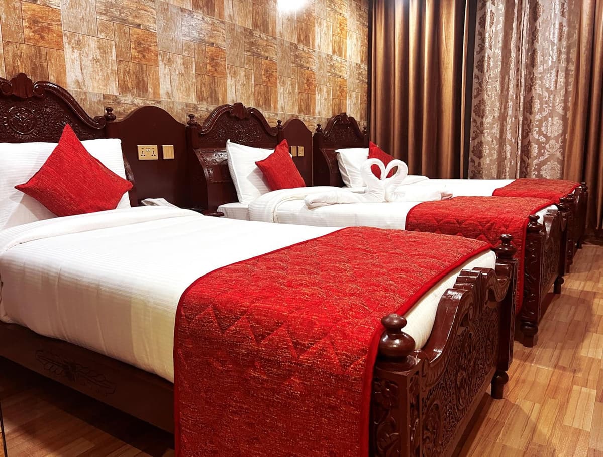 Park Castle room with single beds dressed in white and red