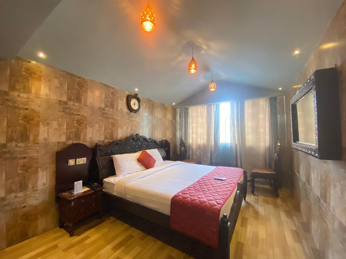 Park King room with a king-size bed under a carved headboard