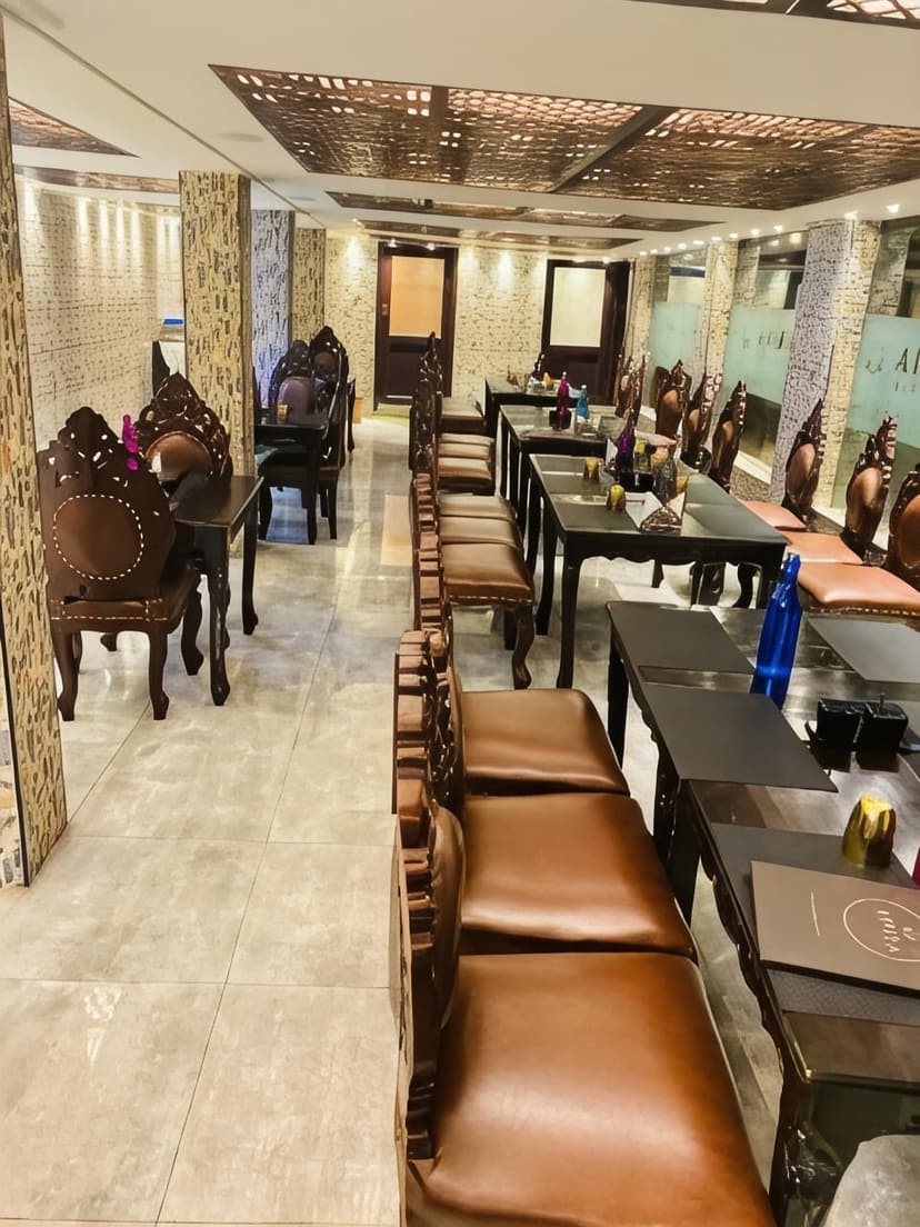 The Kodaikanal restaurant, with carved wooden chairs lining the tables beneath a fretwork ceiling