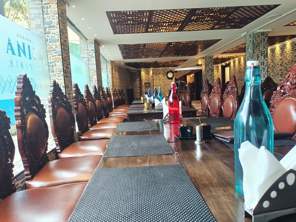 Restaurant tables laid with napkins and water bottles