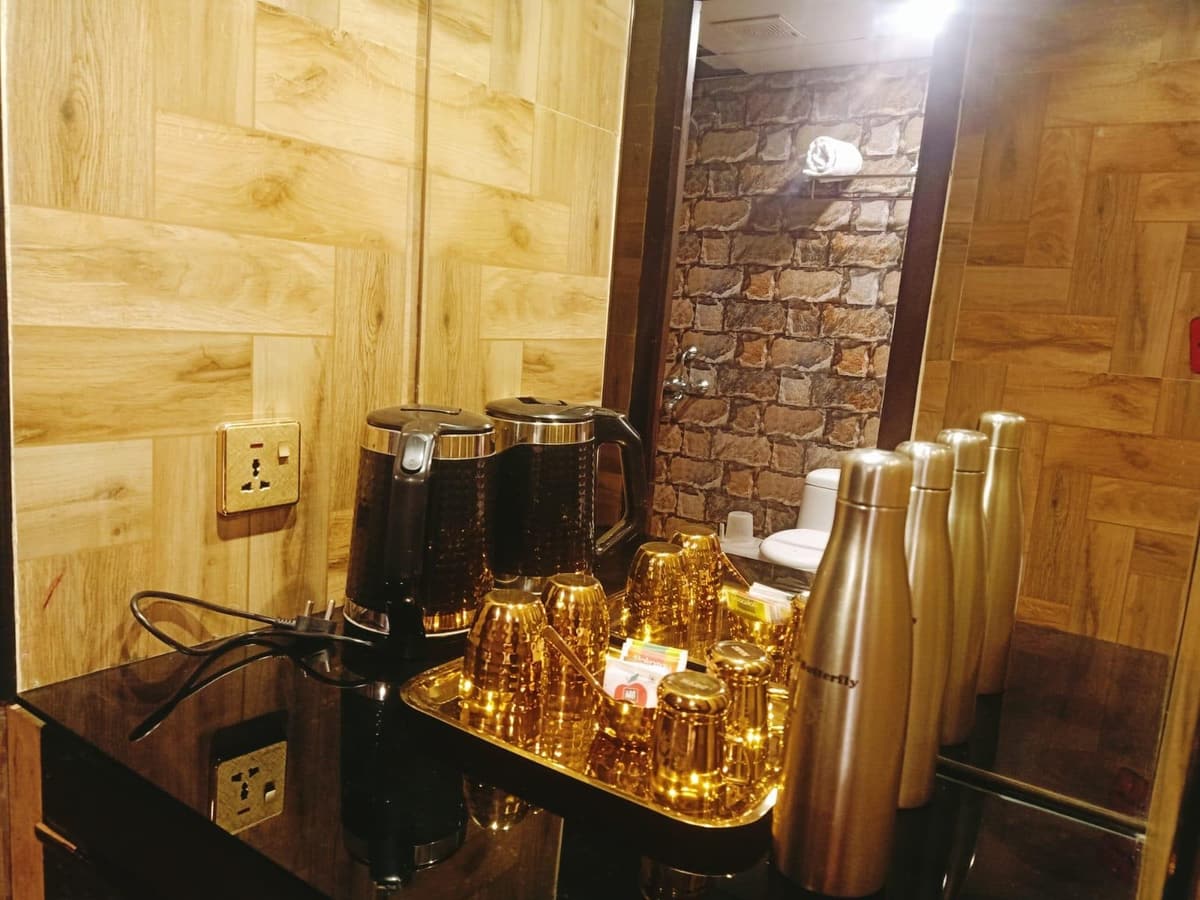 A tea and coffee station with flasks and glasses